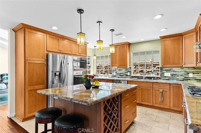 386 Los Altos Ave, Long Beach, CA 90814 - kitchen featuring backsplash, light stone countertops, a center island, a kitchen bar, and recessed lighting