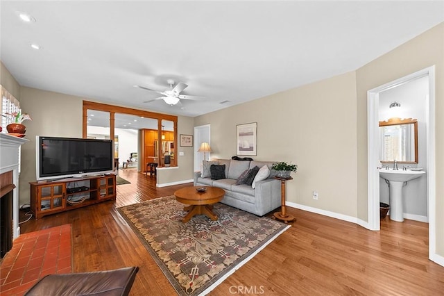 386 Los Altos Ave, Long Beach, CA 90814 - living room with wood finished floors, a fireplace with flush hearth, baseboards, and recessed lighting