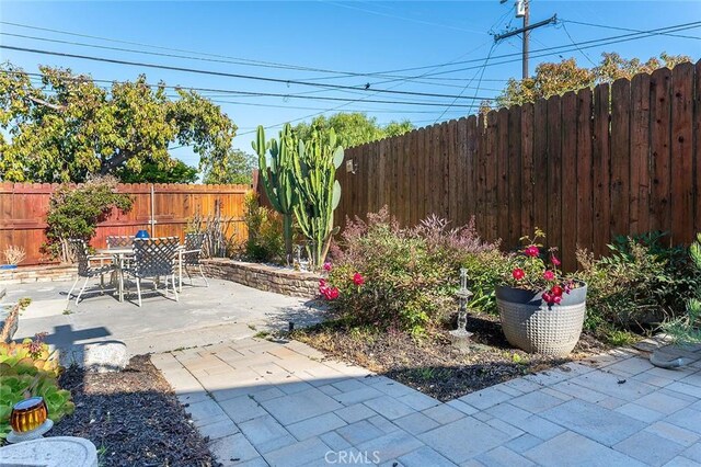 386 Los Altos Ave, Long Beach, CA 90814 - fenced backyard with a patio and outdoor dining space