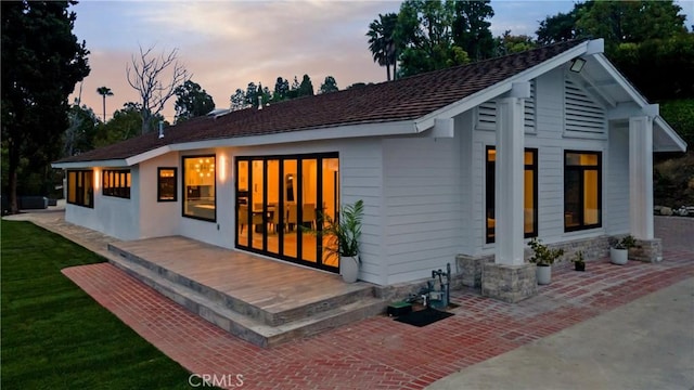 view of back of property at dusk
