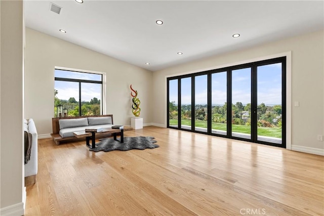 living room featuring recessed lighting, baseboards, and wood finished floors
