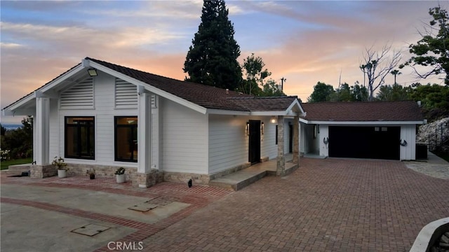view of front of property featuring a garage and decorative driveway