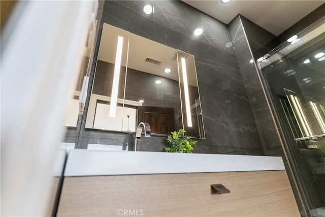 bathroom featuring a shower with door