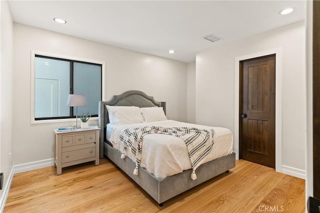 bedroom with baseboards, light wood-type flooring, and recessed lighting