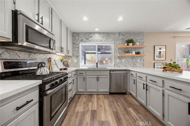 1534 Rowan Gln, Escondido, CA 92025 - kitchen with appliances with stainless steel finishes, decorative backsplash, wood finished floors, recessed lighting, and open shelves