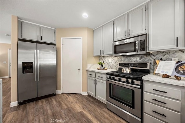 1534 Rowan Gln, Escondido, CA 92025 - kitchen with appliances with stainless steel finishes, decorative backsplash, dark wood-type flooring, light stone countertops, and gray cabinetry
