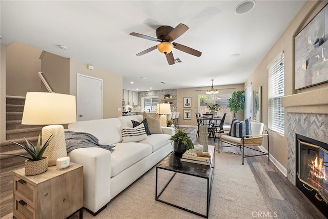 1534 Rowan Gln, Escondido, CA 92025 - living area featuring wood finished floors, a ceiling fan, stairway, and a tile fireplace