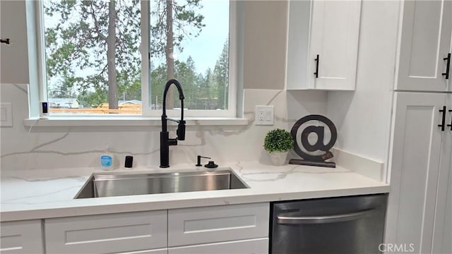 6485 Providence Ct, Magalia, CA 95954 - kitchen featuring stainless steel dishwasher, a sink, white cabinetry, and light stone counters