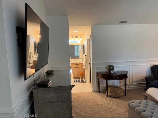 3108 Sumatra Pl, Costa Mesa, CA 92626 - living area featuring a decorative wall, wainscoting, and light carpet