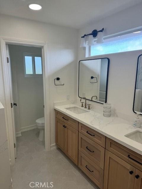 3108 Sumatra Pl, Costa Mesa, CA 92626 - bathroom with toilet, double vanity, tile patterned floors, and baseboards