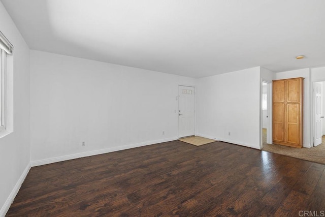 empty room with wood finished floors and baseboards