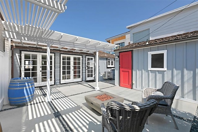 view of patio / terrace with french doors, a pergola, a fire pit, and central AC