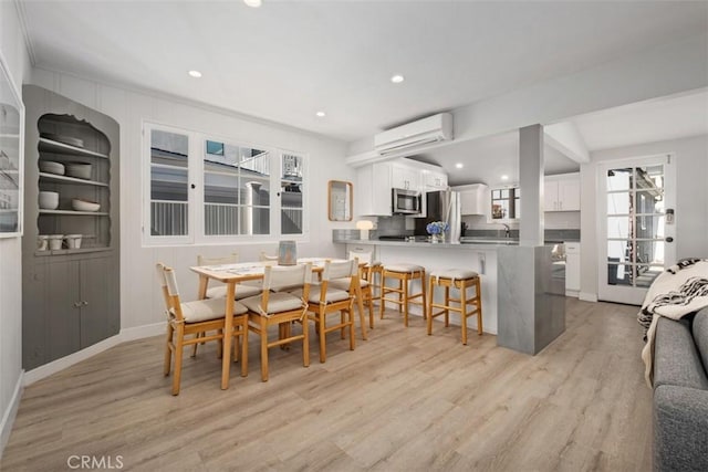 202 Onyx Ave, Newport Beach, CA 92662 - dining space with a wall unit AC, light wood-style flooring, recessed lighting, and baseboards