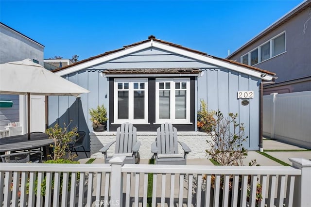202 Onyx Ave, Newport Beach, CA 92662 - rear view of property with board and batten siding, a patio area, and outdoor dining space