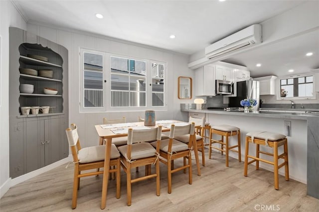 202 Onyx Ave, Newport Beach, CA 92662 - dining space with a wall unit AC, light wood finished floors, healthy amount of natural light, recessed lighting, and crown molding