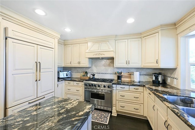 2018 Anaheim Ave, Costa Mesa, CA 92627 - kitchen with custom exhaust hood, high quality appliances, cream cabinets, backsplash, and recessed lighting