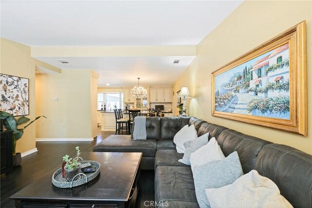 2018 Anaheim Ave, Costa Mesa, CA 92627 - living area with dark wood-type flooring, a chandelier, and baseboards