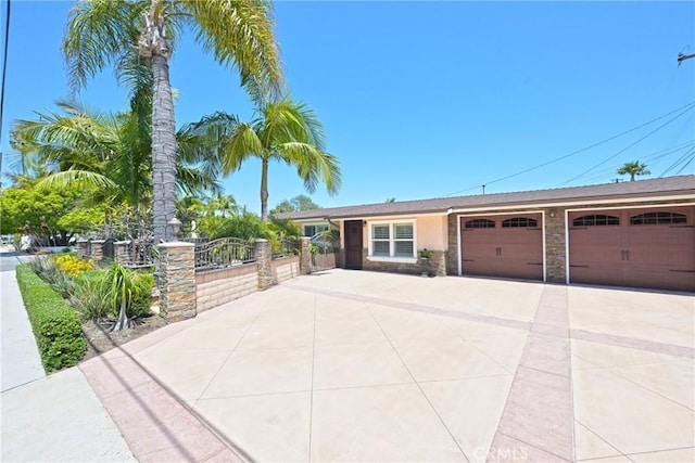 2018 Anaheim Ave, Costa Mesa, CA 92627 - view of front of property with an attached garage, driveway, and stone siding