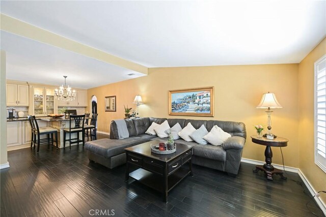 2018 Anaheim Ave, Costa Mesa, CA 92627 - living room featuring a chandelier, dark wood-style floors, and baseboards