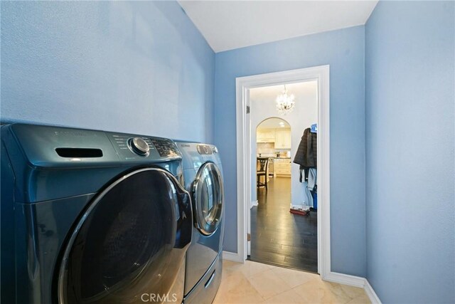 2018 Anaheim Ave, Costa Mesa, CA 92627 - laundry room with washing machine and dryer, a chandelier, baseboards, and light tile patterned floors