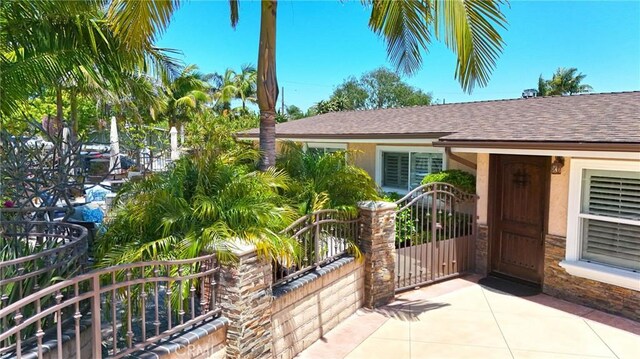 2018 Anaheim Ave, Costa Mesa, CA 92627 - doorway to property with a shingled roof and stucco siding