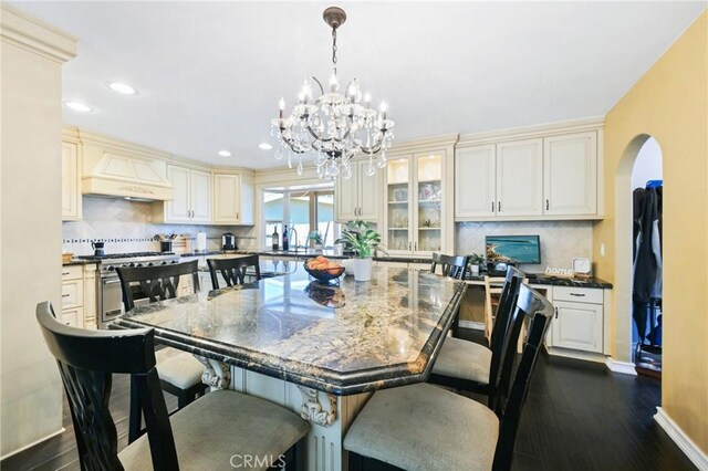 2018 Anaheim Ave, Costa Mesa, CA 92627 - dining area with a chandelier, baseboards, dark wood-style floors, recessed lighting, and arched walkways