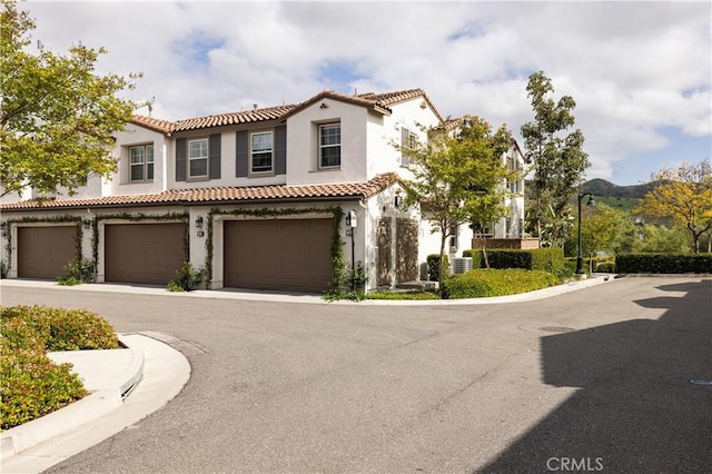 38 Gallo St, Rancho Mission Viejo, CA 92694 - mediterranean / spanish-style home with a tiled roof, stucco siding, central AC, and an attached garage