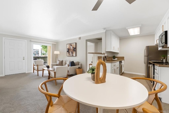 200 Chambers St Unit 19, El Cajon, CA 92020 - dining area featuring ceiling fan, baseboards, crown molding, and light colored carpet