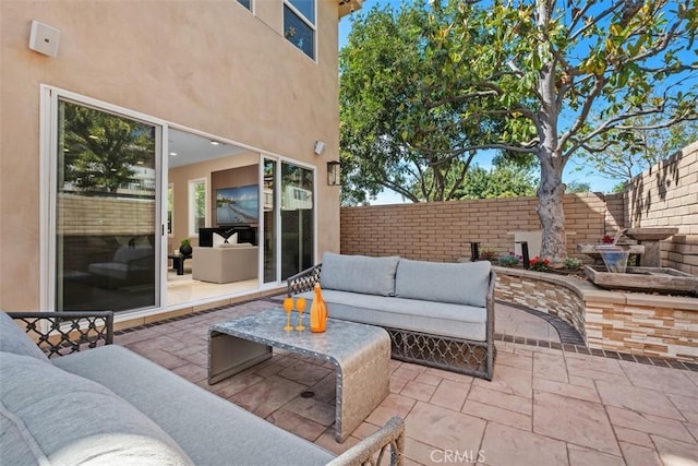 view of patio / terrace featuring an outdoor hangout area and fence