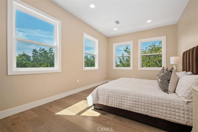 bedroom with baseboards and wood finished floors