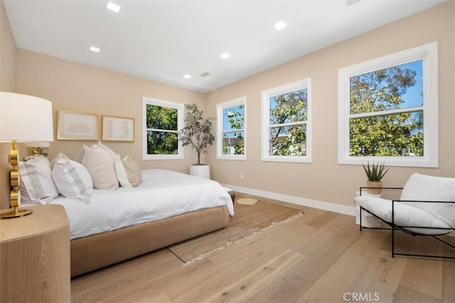 bedroom with light wood-style flooring, baseboards, and recessed lighting