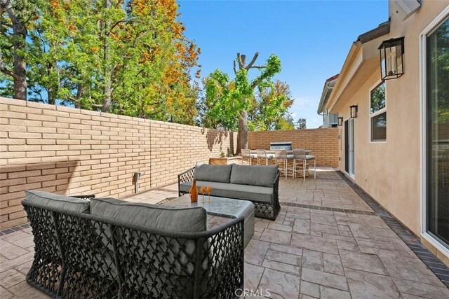 view of patio / terrace featuring outdoor dining area, an outdoor hangout area, and a fenced backyard