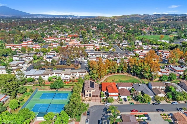 aerial view of property's location with mountains and nearby suburban area