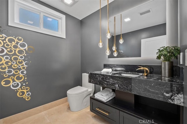 bathroom with toilet and vanity