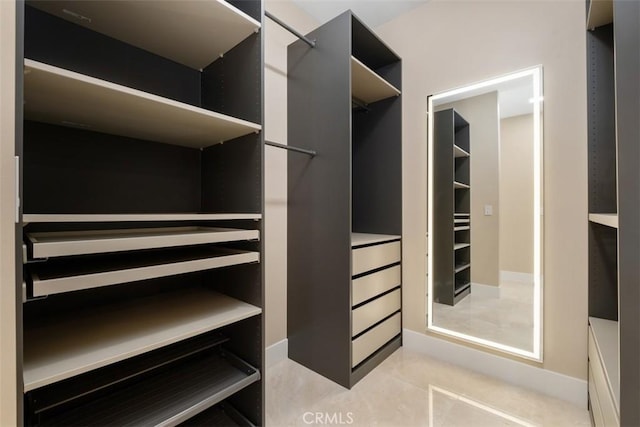 spacious closet with light tile patterned floors