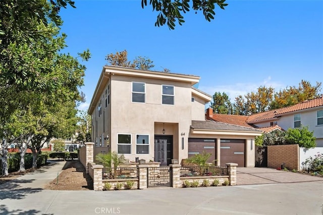 view of front facade featuring concrete driveway, stucco siding, and a garage