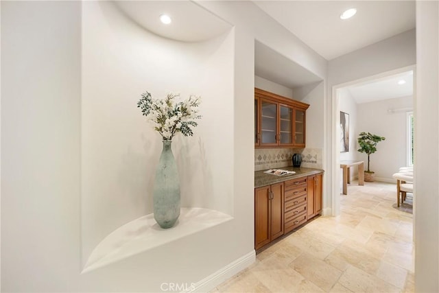 15850 Seville Ln, Encino, CA 91436 - bar area with tasteful backsplash, stone tile floors, baseboards, and recessed lighting