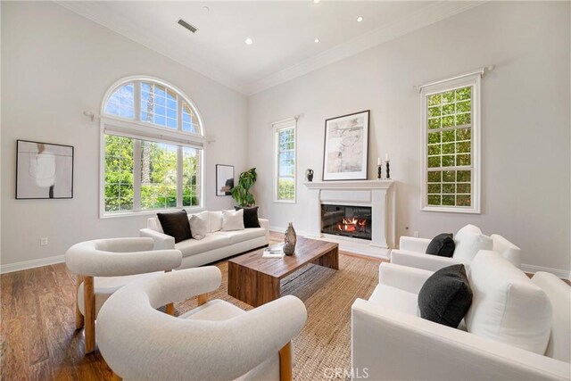15850 Seville Ln, Encino, CA 91436 - living room with plenty of natural light, wood finished floors, ornamental molding, baseboards, and recessed lighting