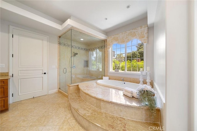 15850 Seville Ln, Encino, CA 91436 - bathroom with a stall shower, a garden tub, vanity, and baseboards