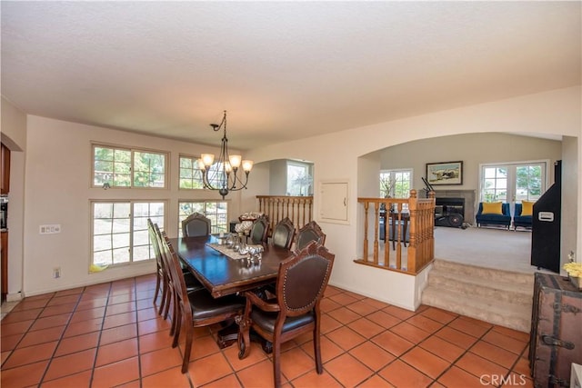 9092 S Rama St, Villa Park, CA 92861 - dining area with a chandelier, healthy amount of natural light, light tile patterned floors, and a glass covered fireplace