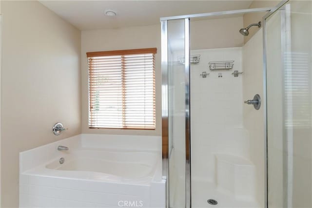 full bathroom with a stall shower and a bath