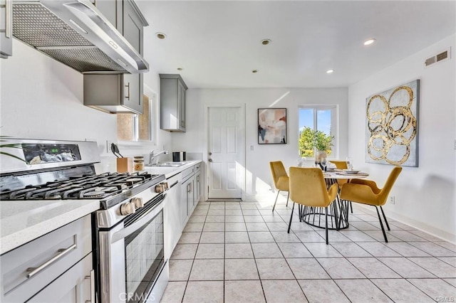 212 Macalester Dr, Walnut, CA 91789 - kitchen with stainless steel range with gas stovetop, extractor fan, gray cabinetry, a sink, and light tile patterned flooring