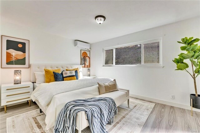 212 Macalester Dr, Walnut, CA 91789 - bedroom featuring a wall unit AC, wood finished floors, and baseboards