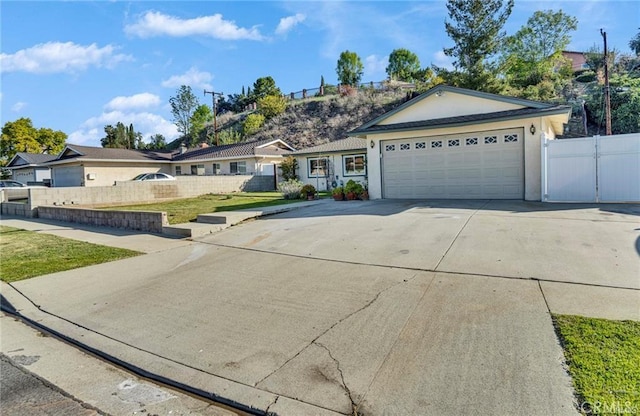 212 Macalester Dr, Walnut, CA 91789 - ranch-style home featuring concrete driveway, a garage, and stucco siding