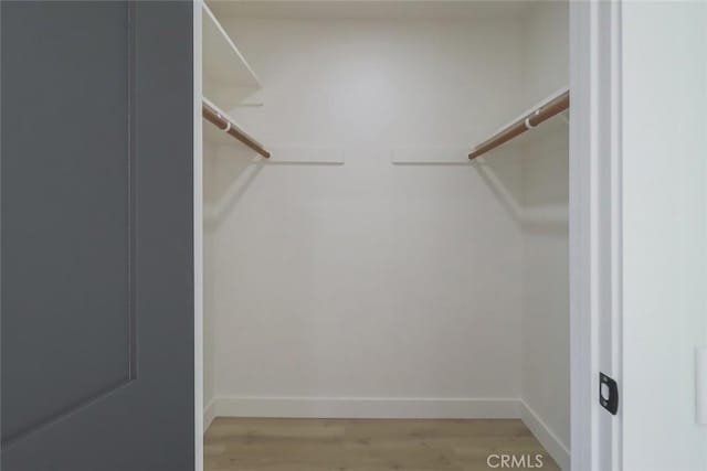 26120 Adamor Rd, Calabasas, CA 91302 - walk in closet featuring light wood-style floors