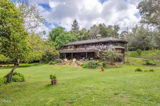 view of green lawn featuring a wooden deck