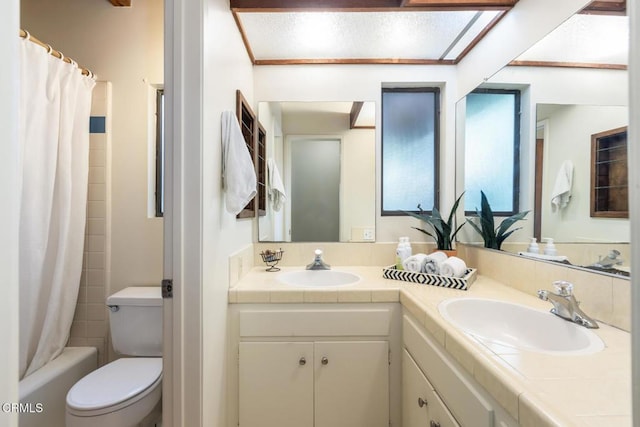 full bathroom featuring double vanity, toilet, and shower / bath combination with curtain