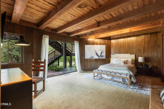 carpeted bedroom featuring beamed ceiling, wooden walls, access to exterior, and wood ceiling