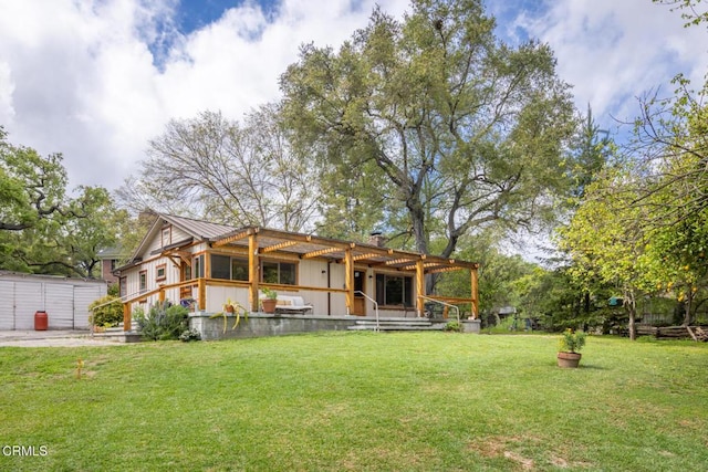 rear view of property featuring a lawn and metal roof