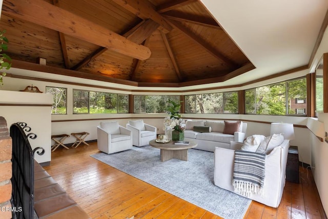 living room featuring wood-type flooring, wooden ceiling, plenty of natural light, and a brick fireplace